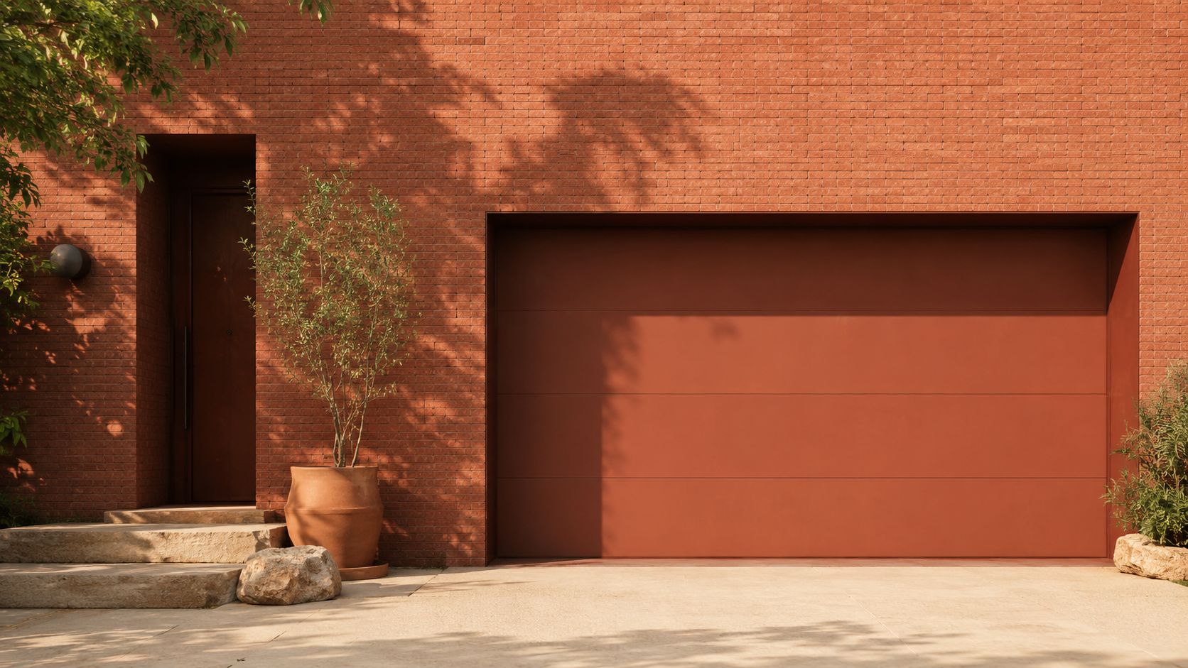 A modern residence featuring a matching red garage door against a textured red brick exterior wall.